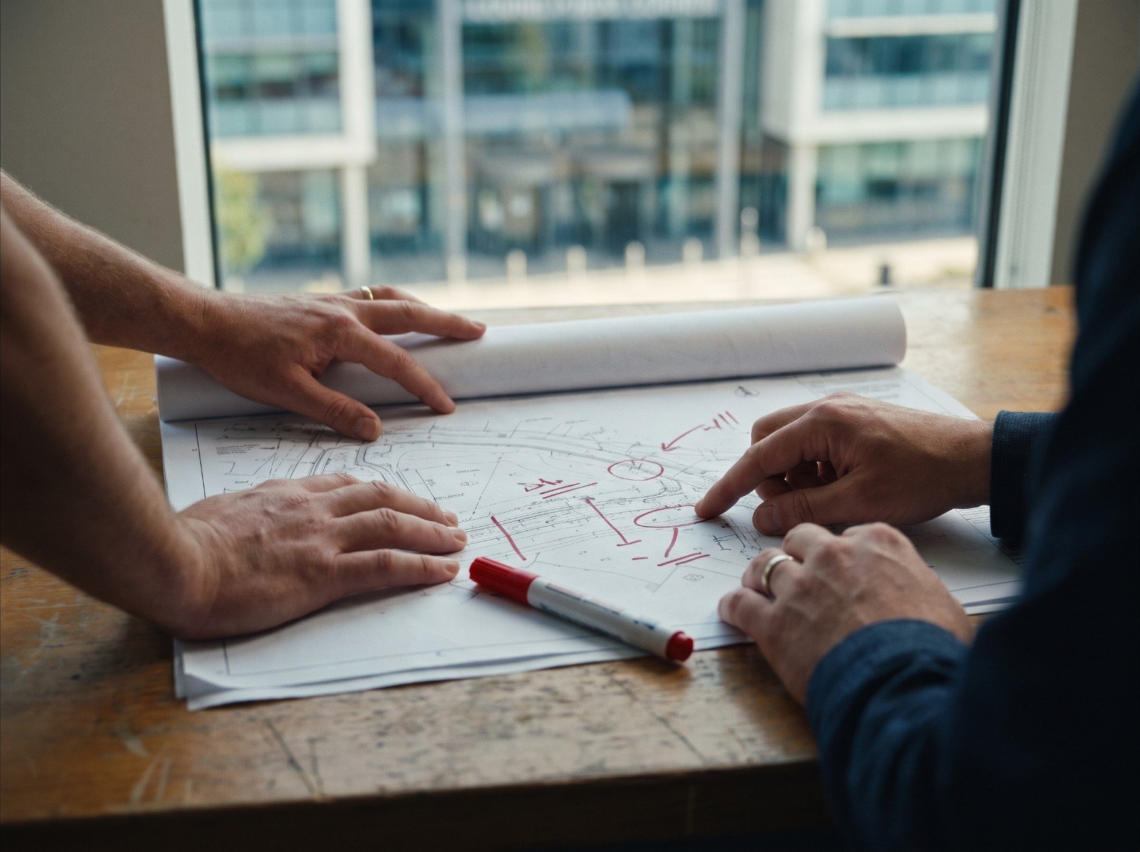 Marked-up civil drawings on a table
